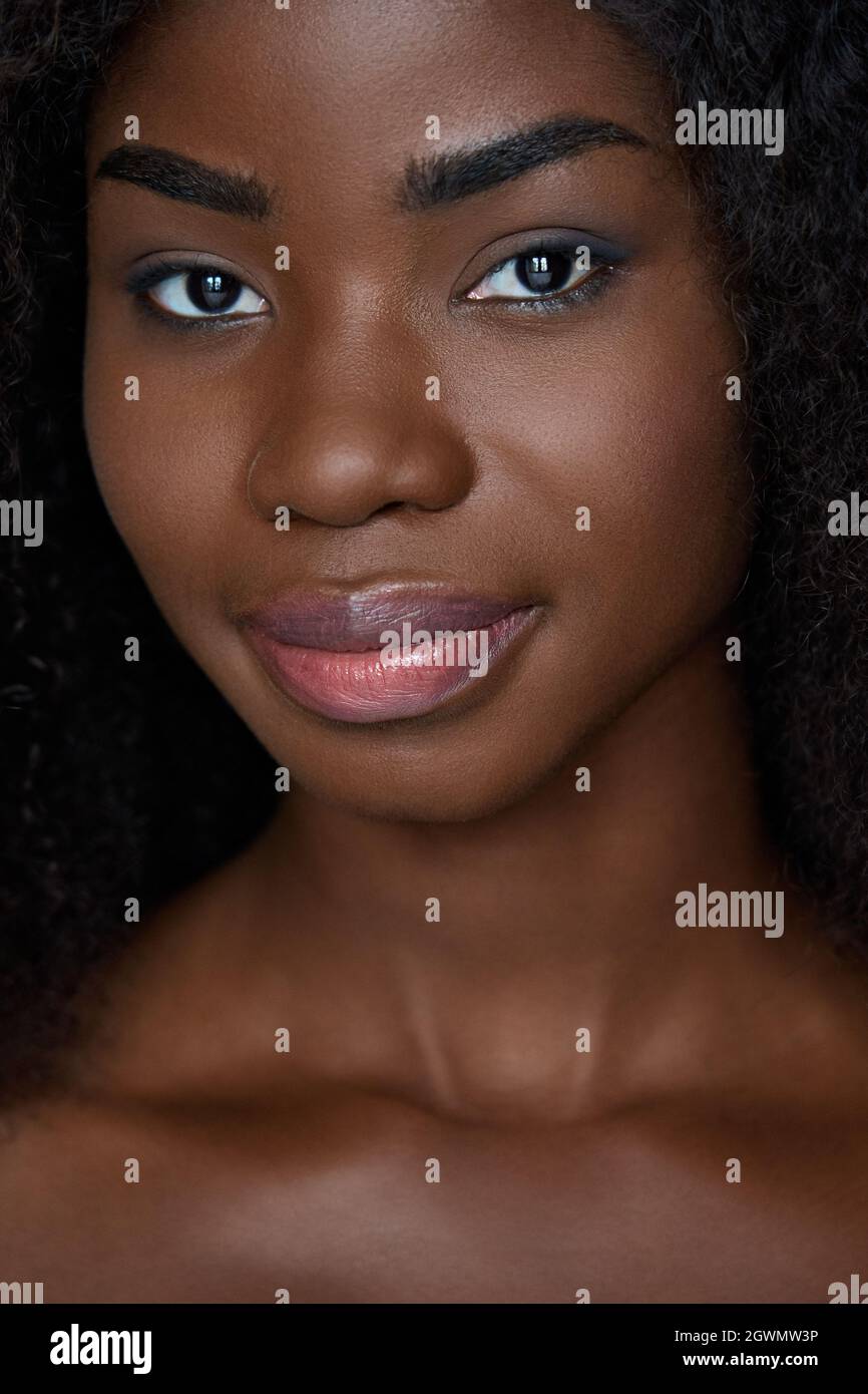 Closeup vertical shot of beautiful young black girl. Beauty skincare concept. Stock Photo