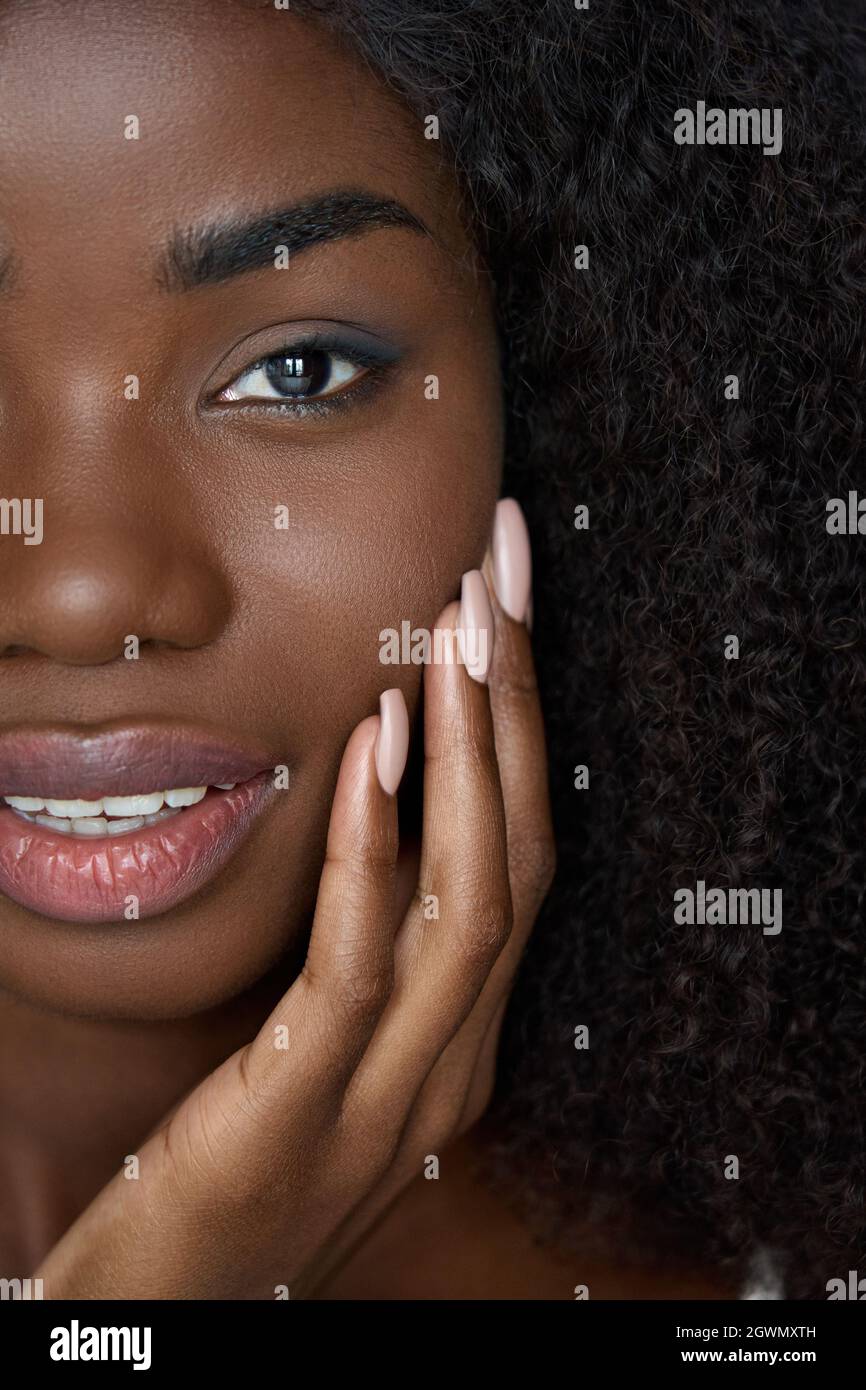 Happy black young woman touching flawless face skin, closeup vertical ...