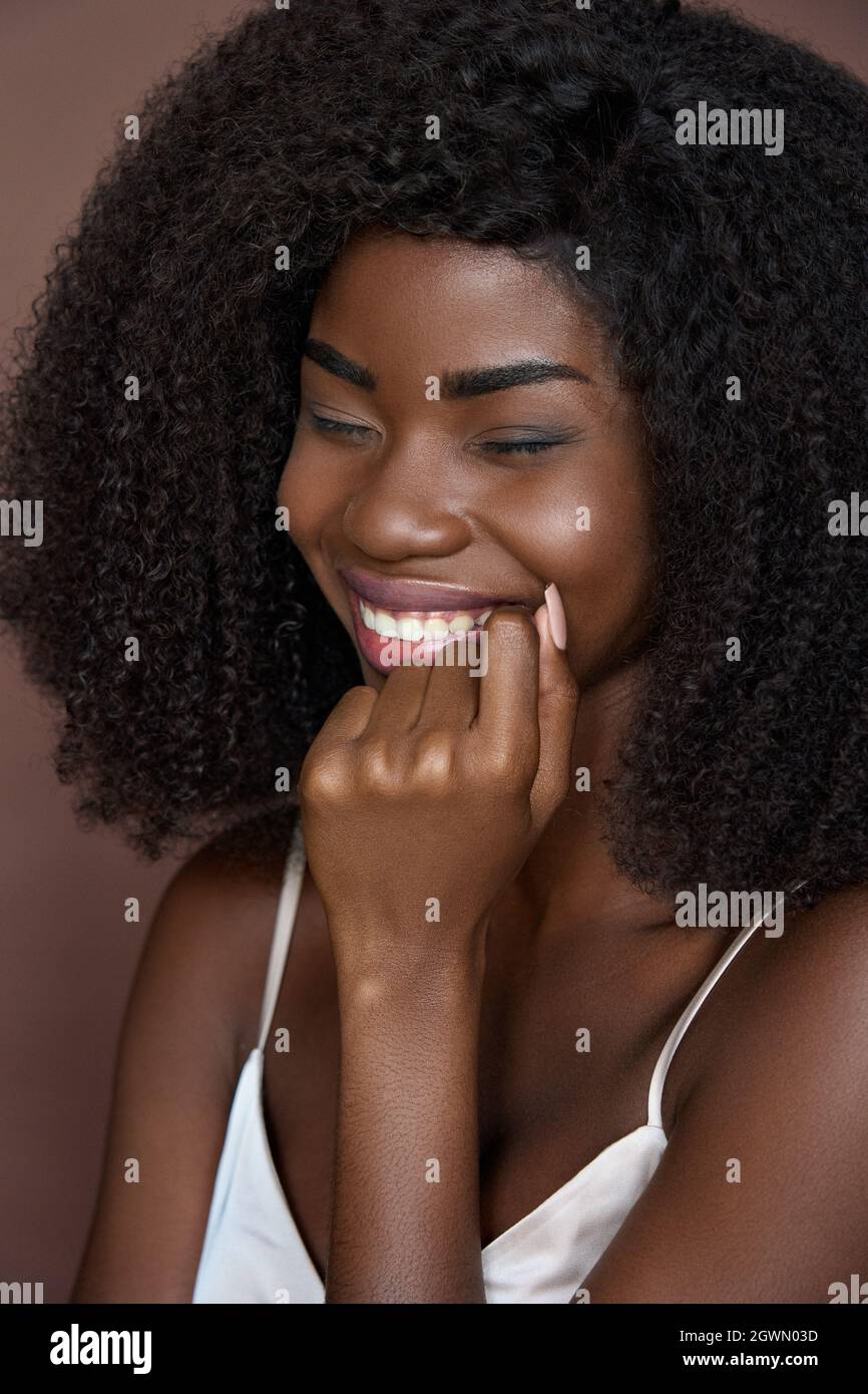 Closeup vertical portrait of young cheerful happy black girl. Beauty concept. Stock Photo