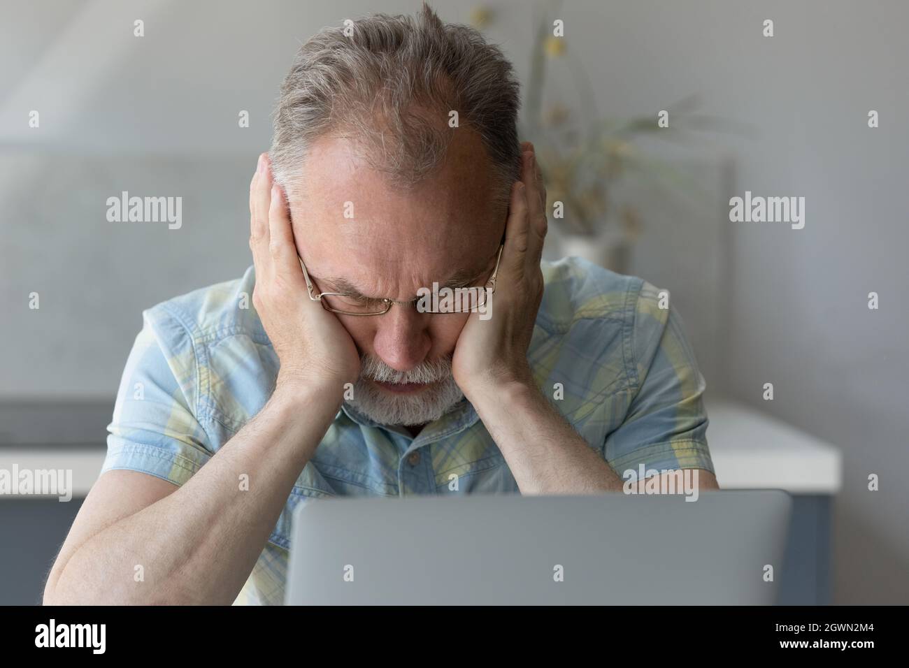 Frustrated middle aged man having problems using computer. Stock Photo