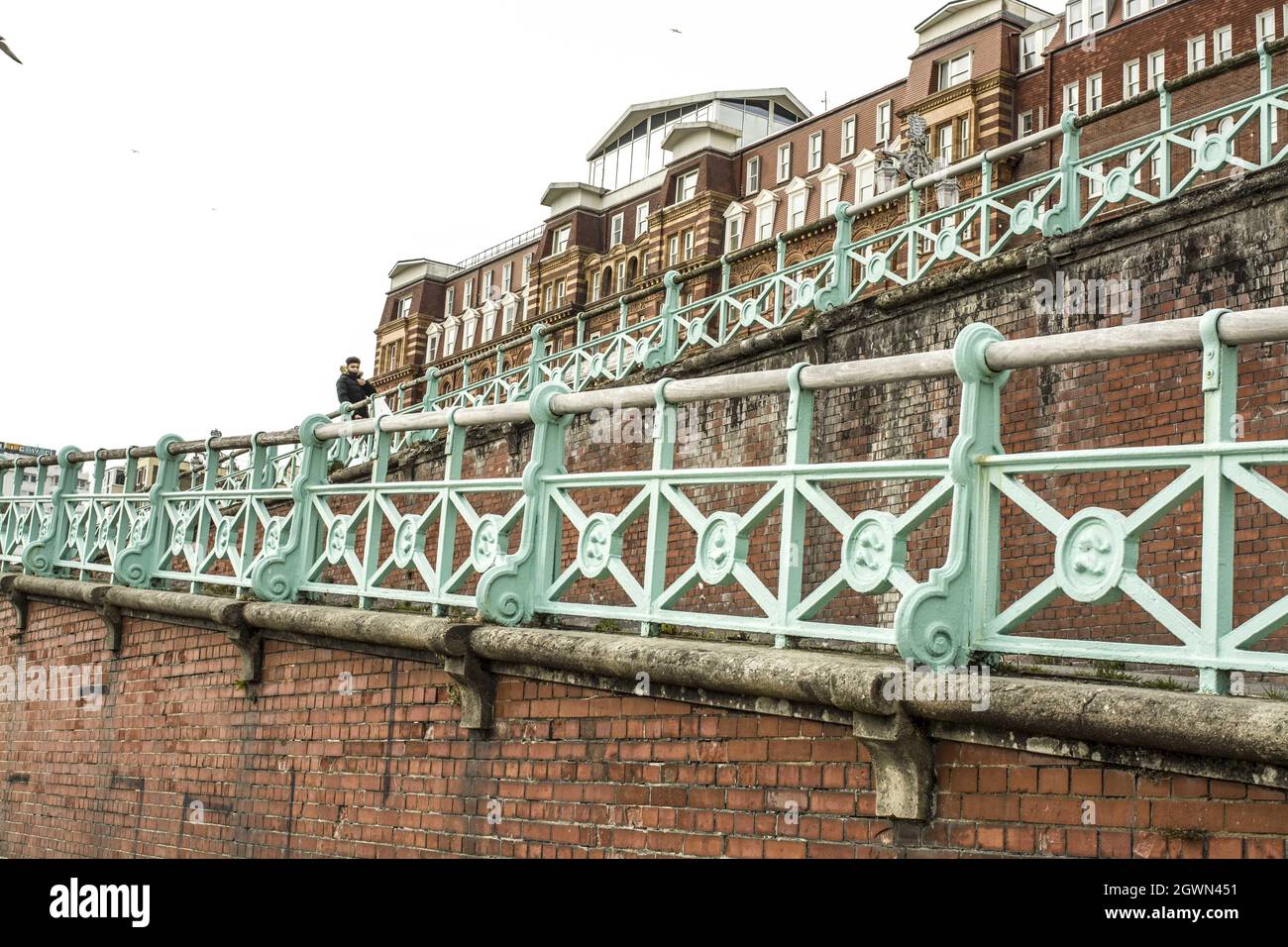 Brick walls in Brighton and green railings at Brighton seafront Stock