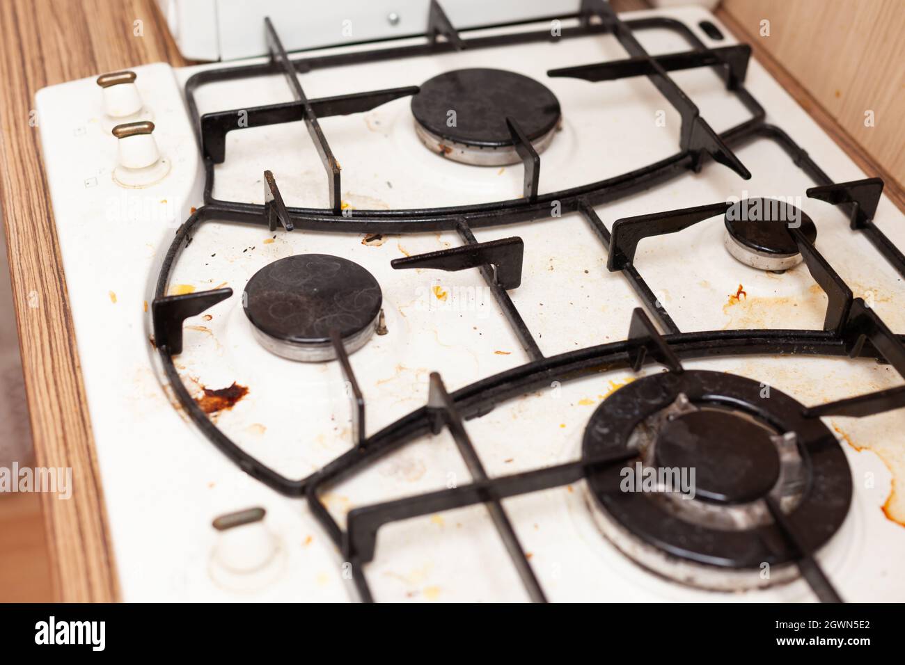 dirty beige cooking gas stove, four burners Stock Photo