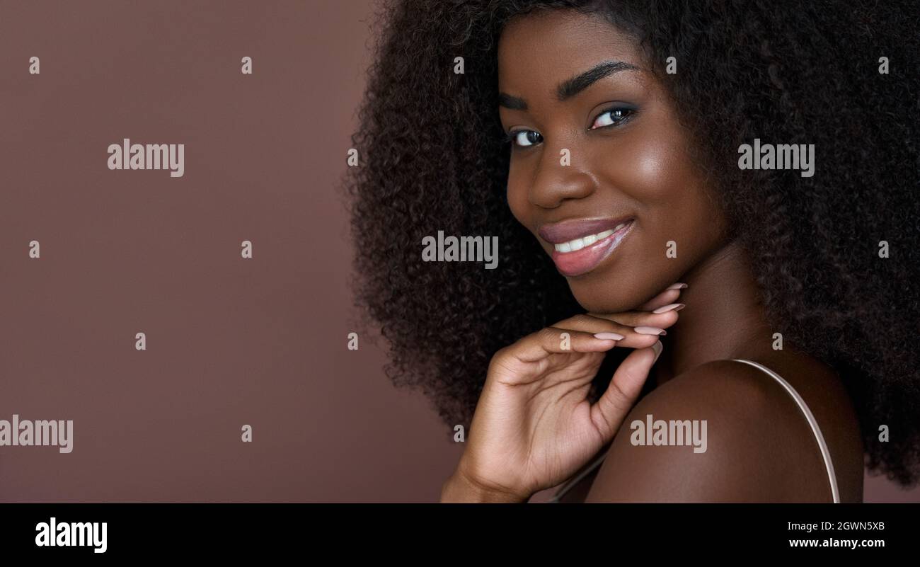 Beautiful happy young black girl smiling. Skincare concept. Closeup portrait. Stock Photo