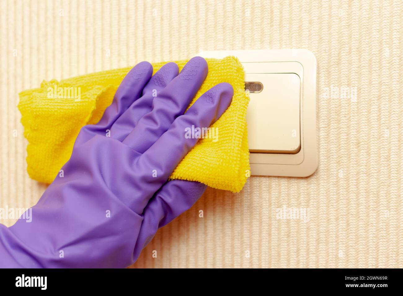 https://c8.alamy.com/comp/2GWN69R/female-hand-in-a-rubber-glove-disinfects-the-room-switch-2GWN69R.jpg