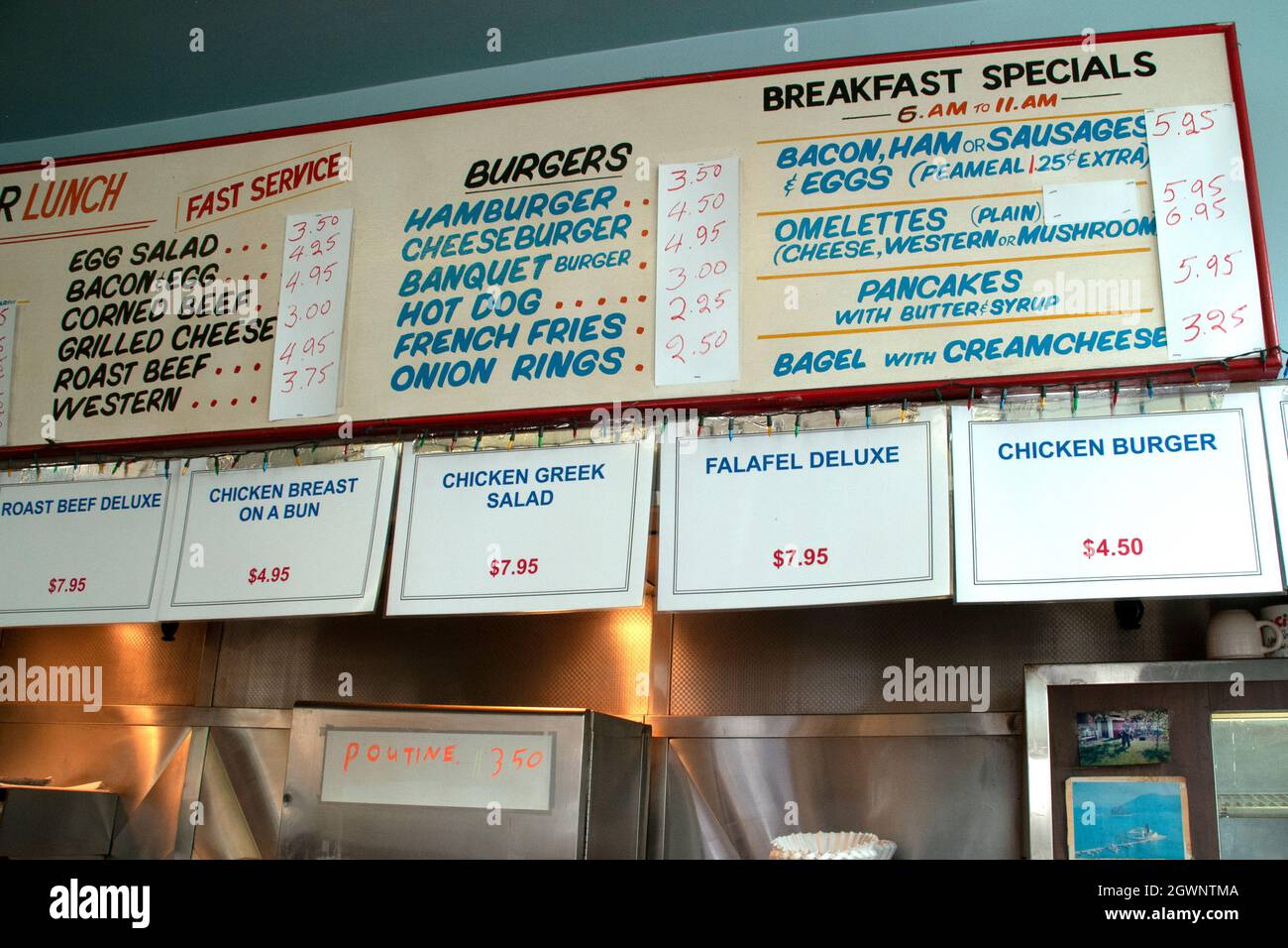 The interior amd menu sign above the kitchen at a retro greasy spoon diner and restaurant in Toronto, Ontario, Canada. Stock Photo