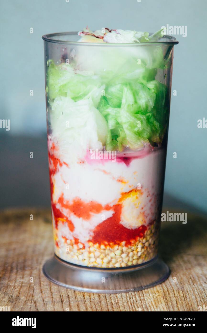 Layered Mixed Smoothie Made Of Banana, Strawberry, Iceberg Lettuce And