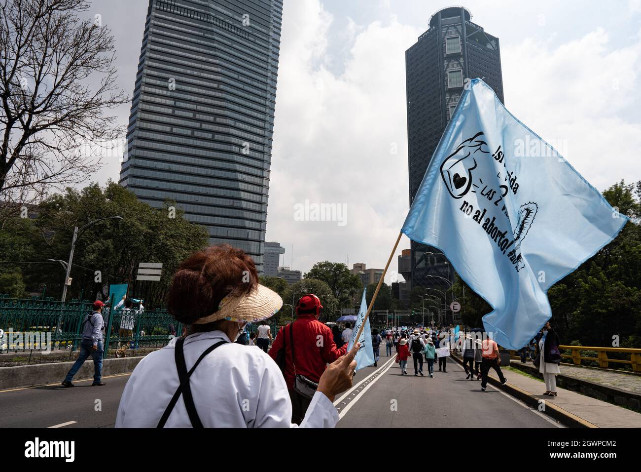 Mexico City, Mexico. 03rd Oct, 2021. A demonstrator is seen waving an anti-abortion flag during the pro-life demonstration march.Thousands march in Mexico City at a pro-life and pro-women demonstration march. Demonstrators came in from all over the country, with different states or organizations written on their t-shirts. The march comes after the Mexican Supreme Court ruled that abortion is no longer a crime since September 2021. Credit: SOPA Images Limited/Alamy Live News Stock Photo