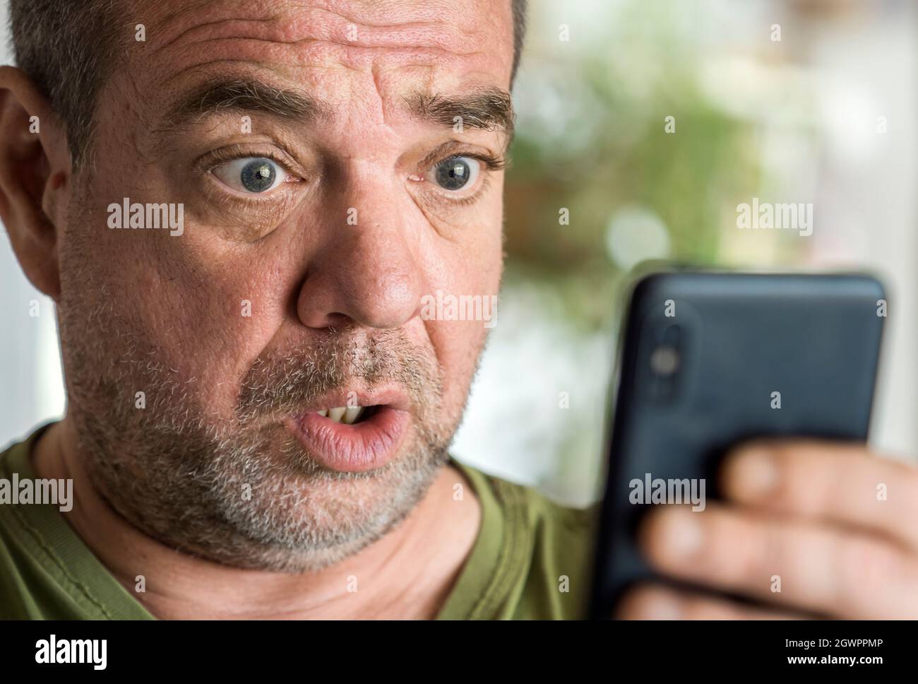 Surprised Man With A Smartphone. Bad News Concept Stock Photo