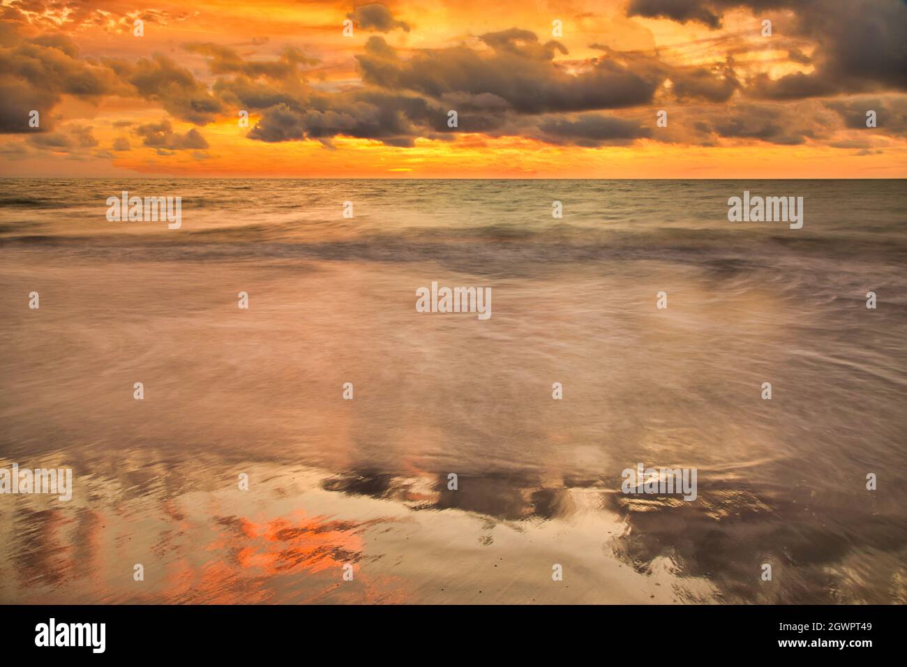 A beautiful seascape under a cloudy sunset sky Stock Photo - Alamy