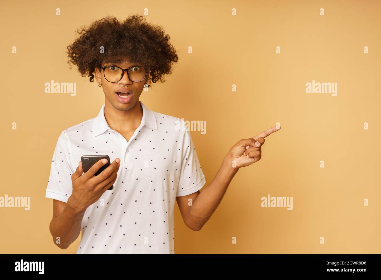 Amazed man with glasses indicates something with hand Stock Photo