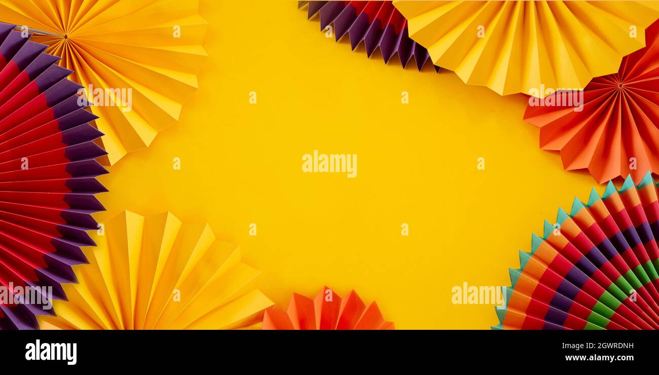 Colorful paper ornaments on yellow background Stock Photo - Alamy