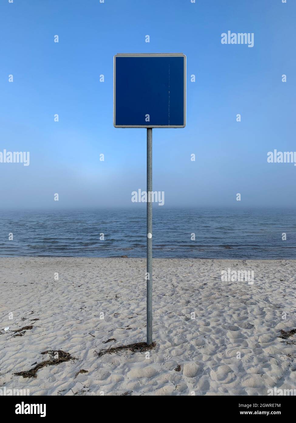 Scenic View Of Empty Sign On Beach Against Clear Blue Sky Stock Photo