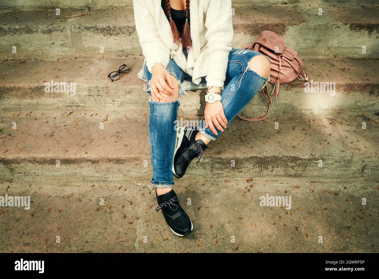 Knitted Cardigan And Ripped Jeans Sits 
