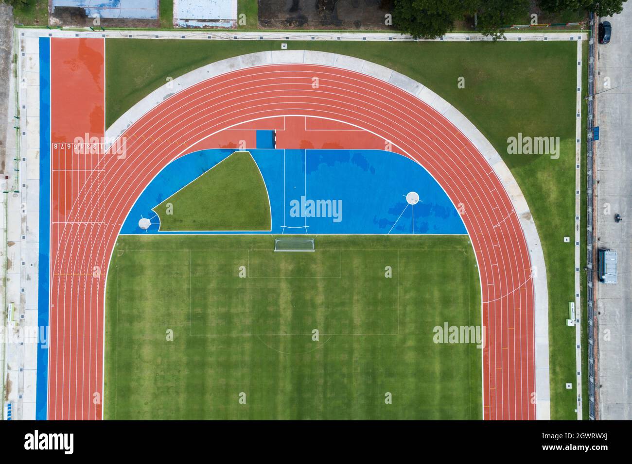 Aerial view of empty new soccer field from above with running tracks