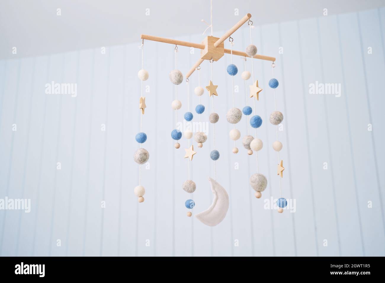 Low Angle View Of Wind Chime Hanging Against Wall At Home Stock Photo