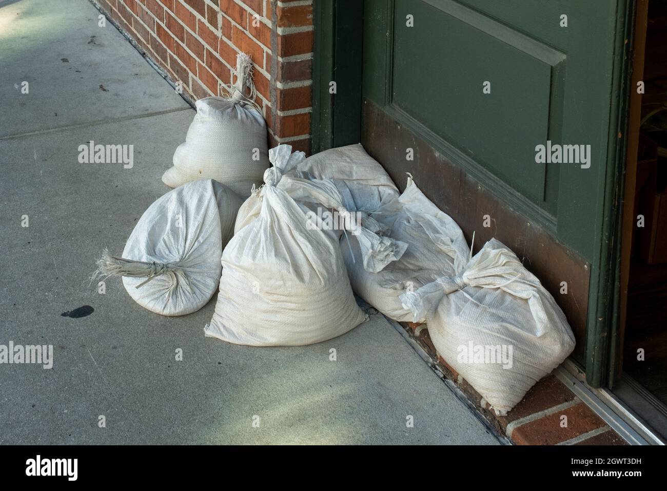 A group of sandbags is used to protect a front door from water damage