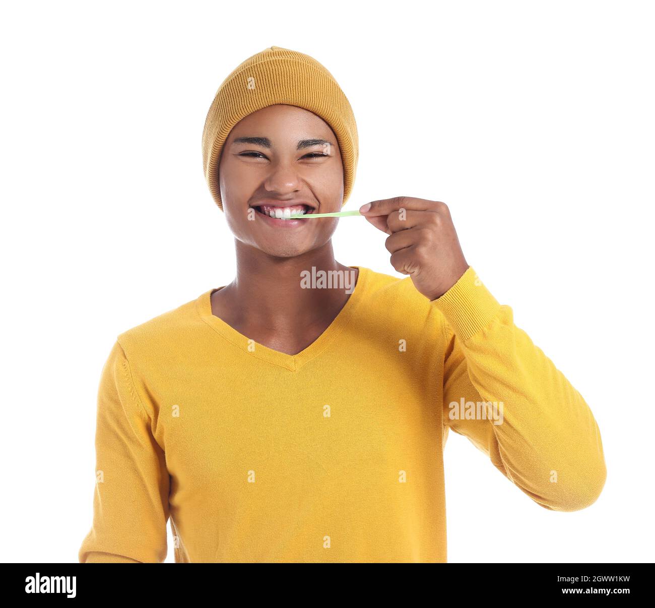 Happy African-American guy with chewing gum on white background Stock Photo