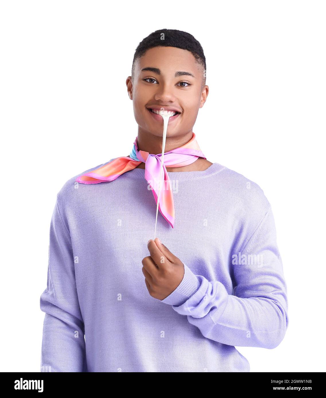 Happy African-American guy with chewing gum on white background Stock Photo