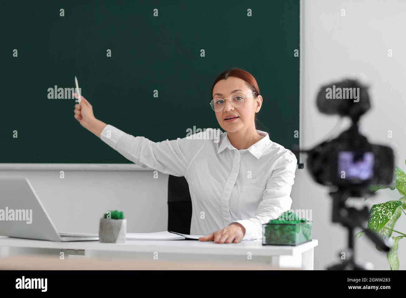 Teacher recording video for his students in classroom Stock Photo Alamy