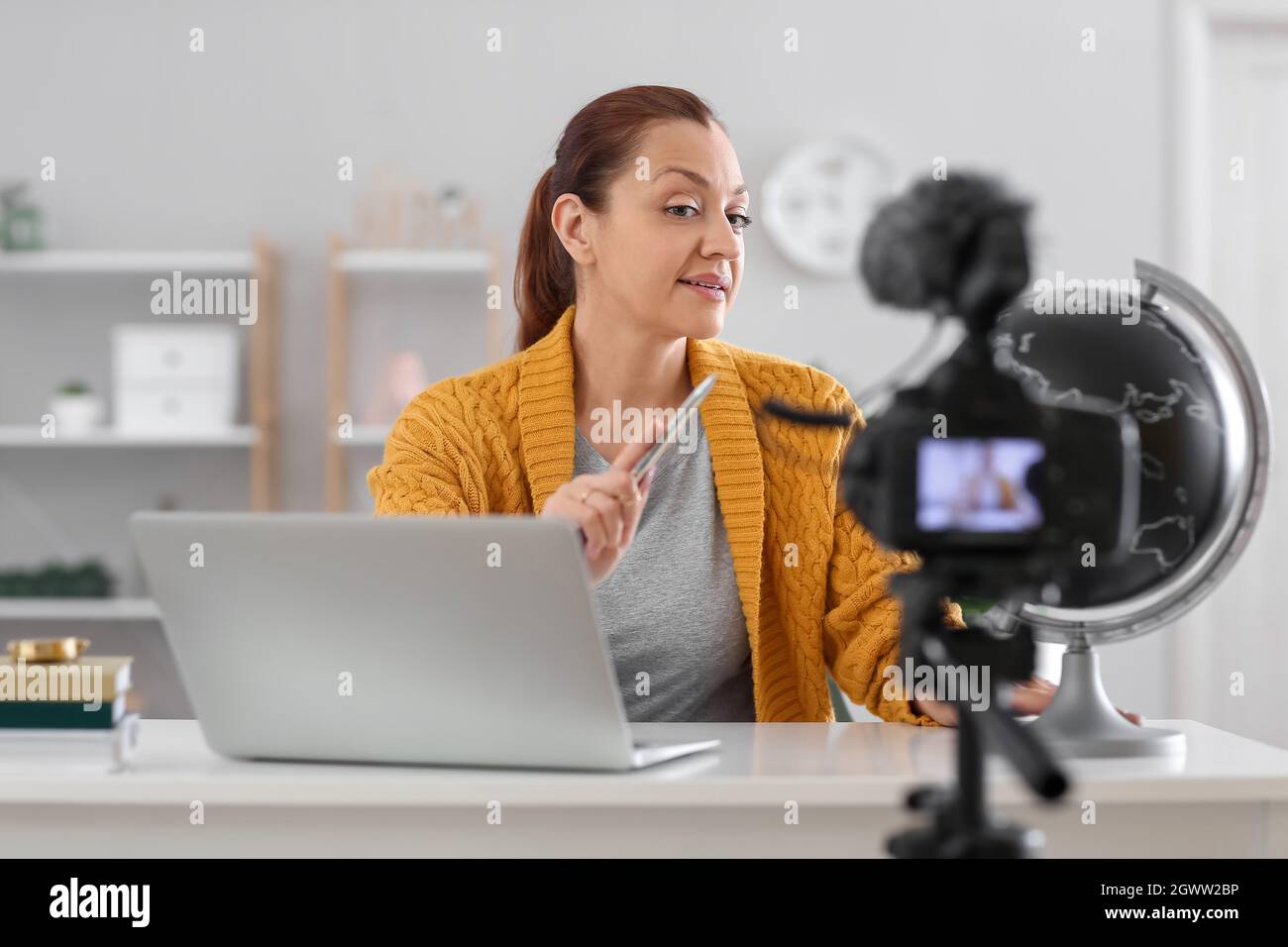 Teacher recording video for his students at home Stock Photo Alamy