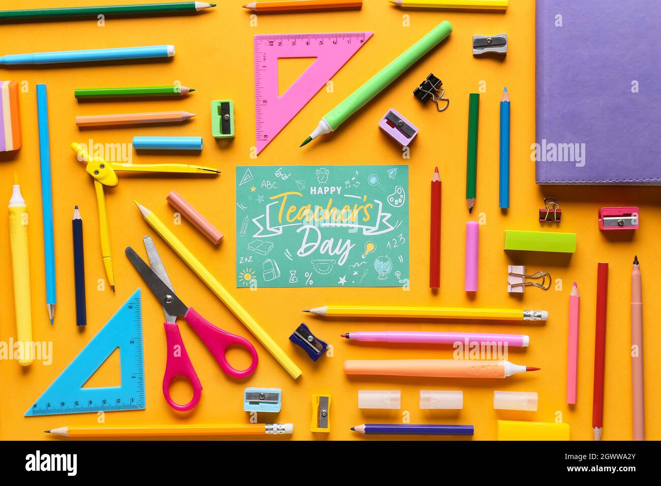 https://c8.alamy.com/comp/2GWWA2Y/concept-of-teachers-day-school-supplies-and-greeting-card-on-color-background-top-view-2GWWA2Y.jpg