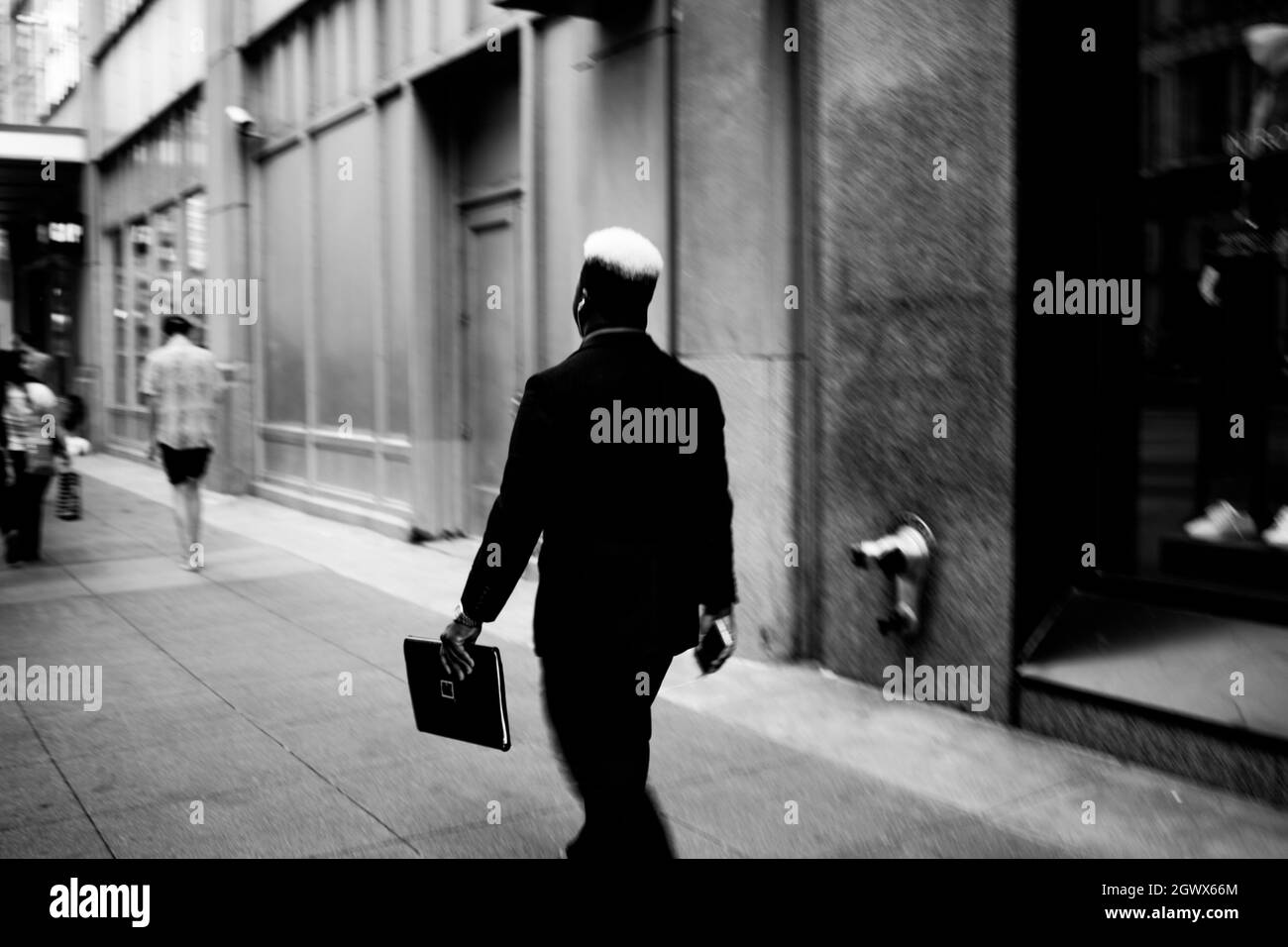 Black and white man walking on sidewalk Black and White Stock Photos ...