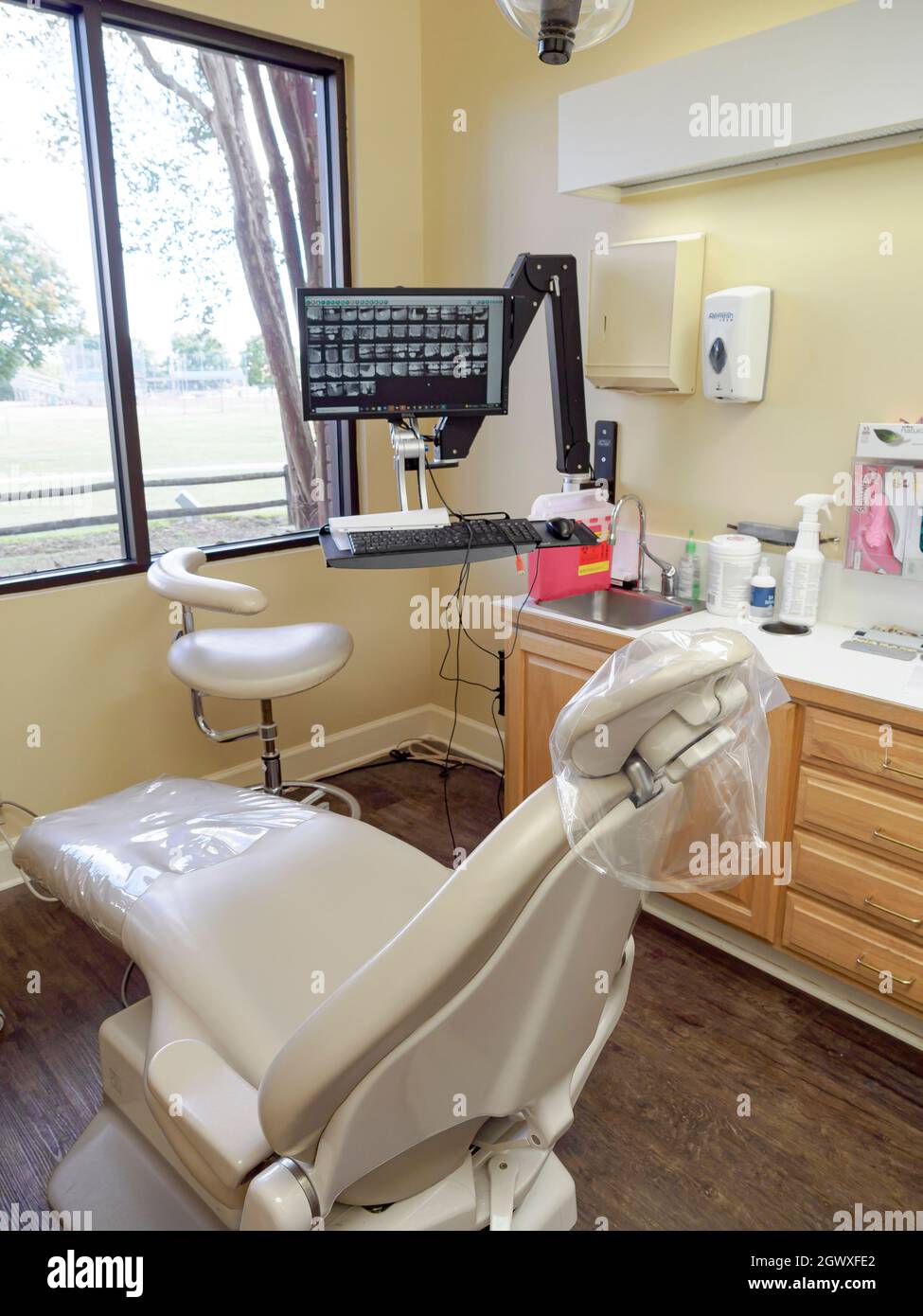 Empty dentist exam room with dental chair with dental equipment and dental tools. Stock Photo