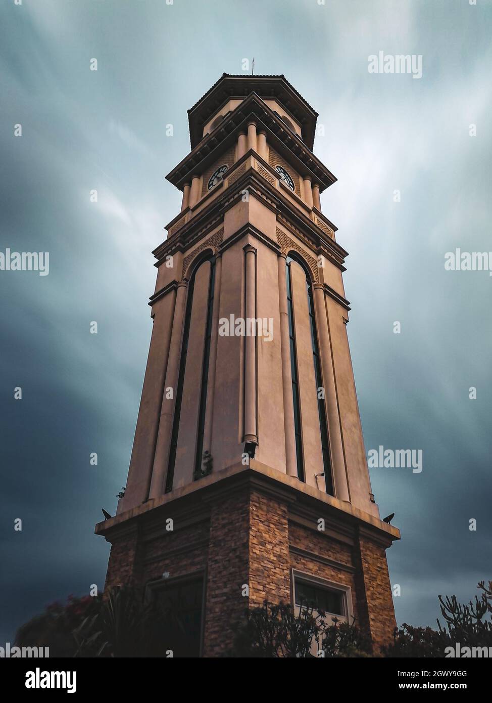 Low Angle View Of Clock Tower With Silky Clouds Background Stock Photo
