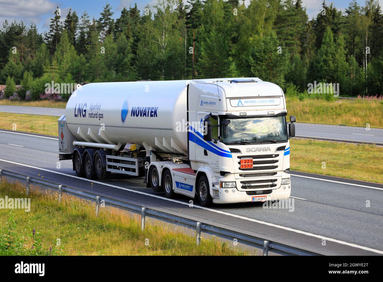 White Scania semi tank truck hauls Novatek LNG, Liquified natural gas, ADR 223-1972, on multiple lane highway. Salo, Finland. July 9, 2021. Stock Photo