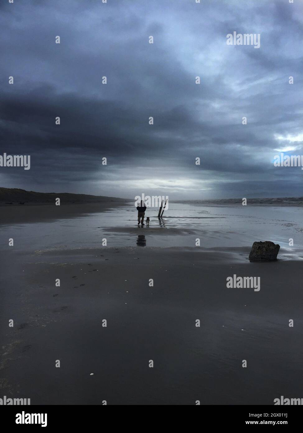 Silhouette Man On Beach Against Sky Stock Photo