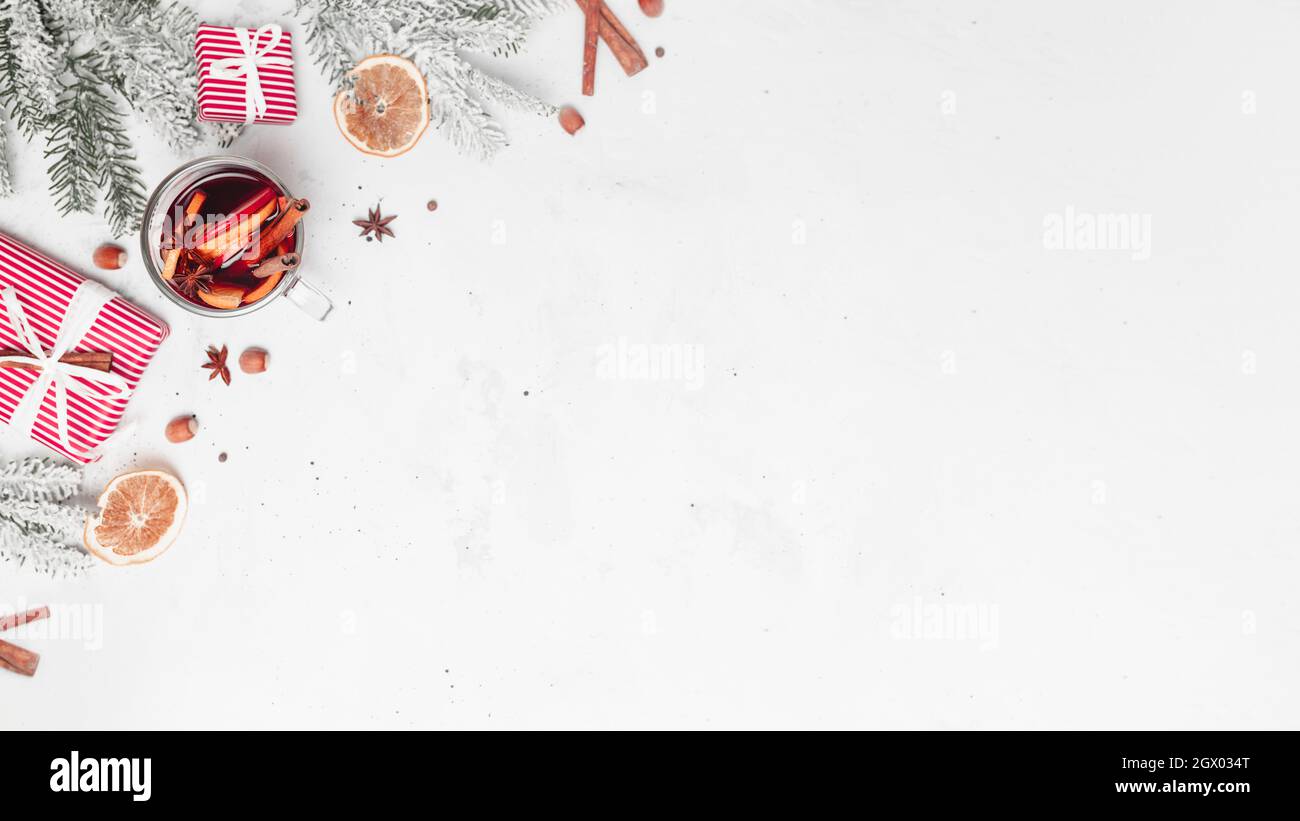 Christmas banner flat lay with glass cup of Mulled Wine, gift box, decorations Stock Photo
