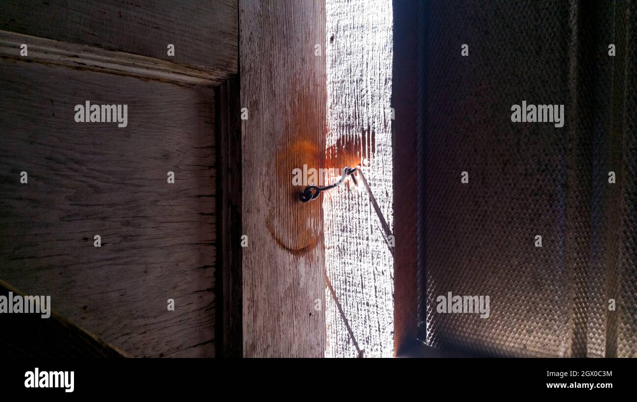 Door Ajar With Latch Hook And Eye Lock Stock Photo Alamy