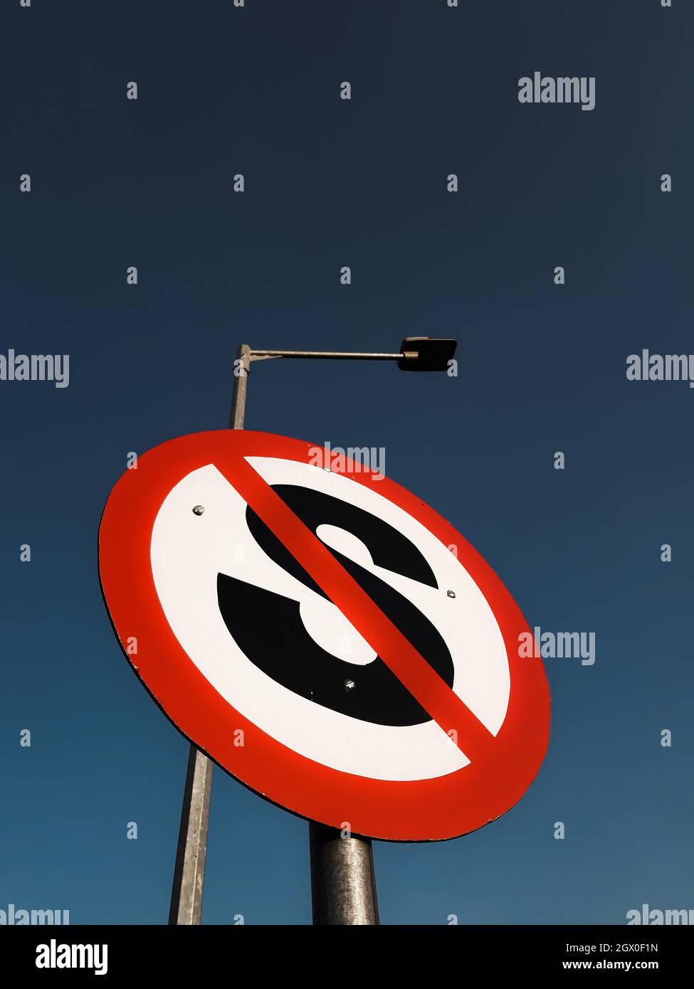 Low Angle View Of Road Sign And Electric Street Lamp Against Blue Sky Stock Photo