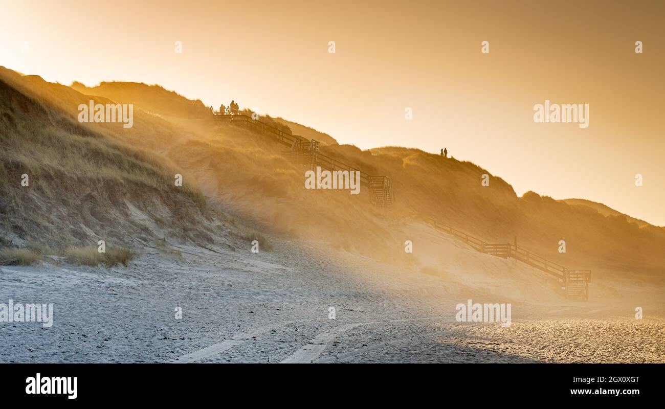 Dune path on Sylt - sunbeams break over the edge of the dune on the beach between Wenningstedt and Westerland Stock Photo
