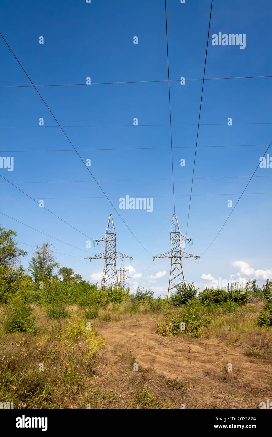 High voltage electrical lines and equipment against the blue sky. Stock Photo