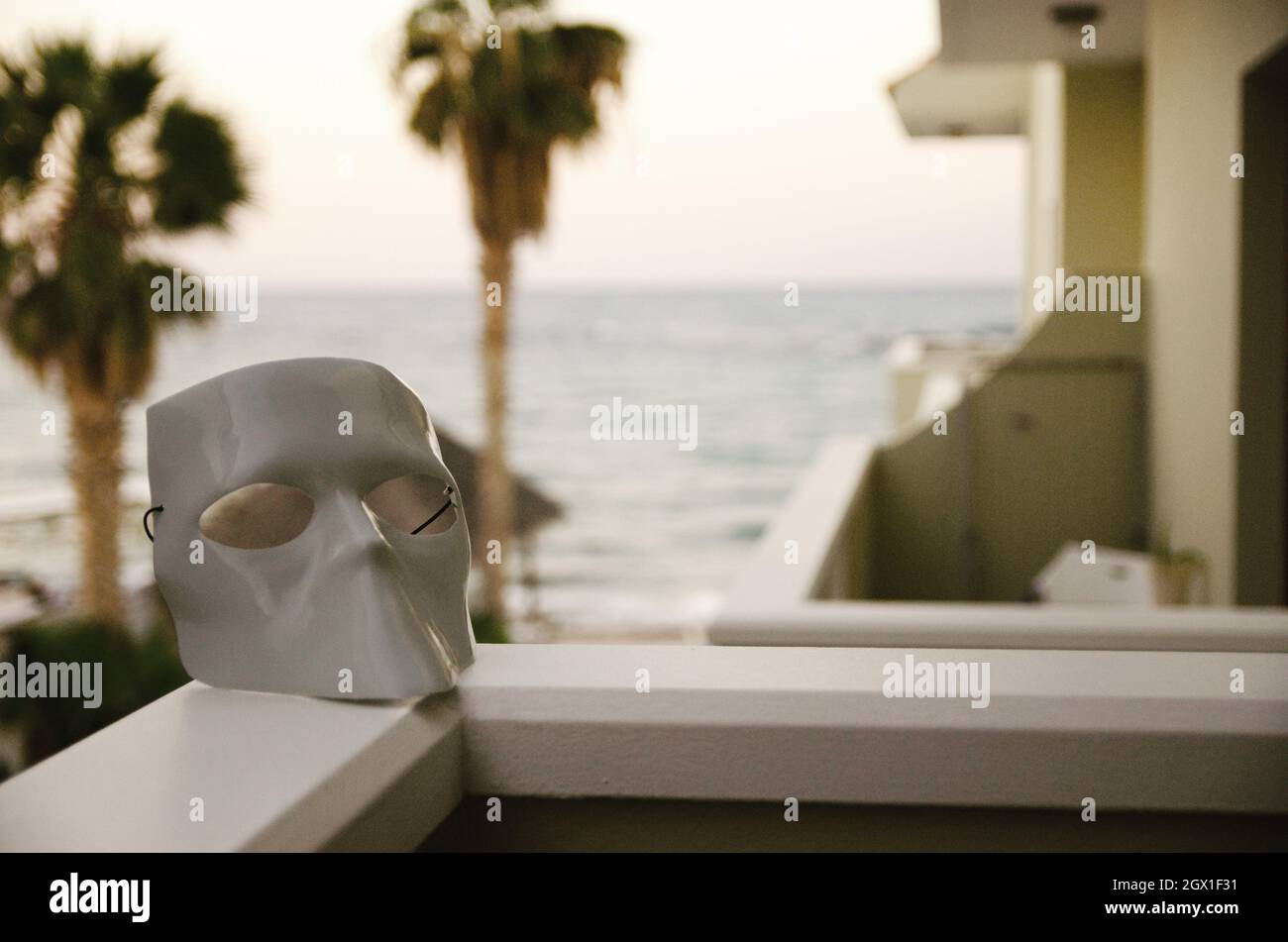 Close-up Of The Mask On The Terace  With Palm Tree Background By Sea Against Sky Stock Photo