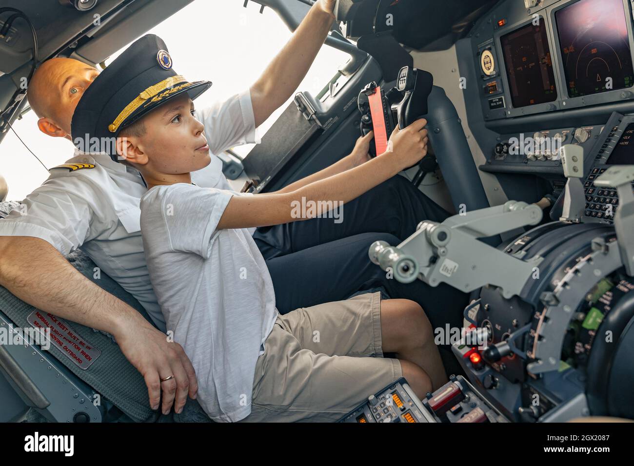Little boy in a pilot cap in the cockpit Stock Photo - Alamy