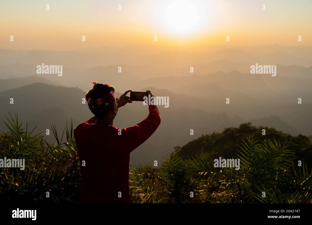 Rear View Of Man Photo Graphing During Sunset Stock Photo