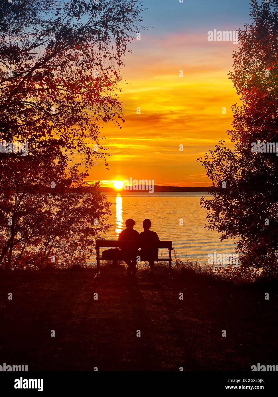 Couple Sitting On Bench At Sunset High Resolution Stock Photography and ...