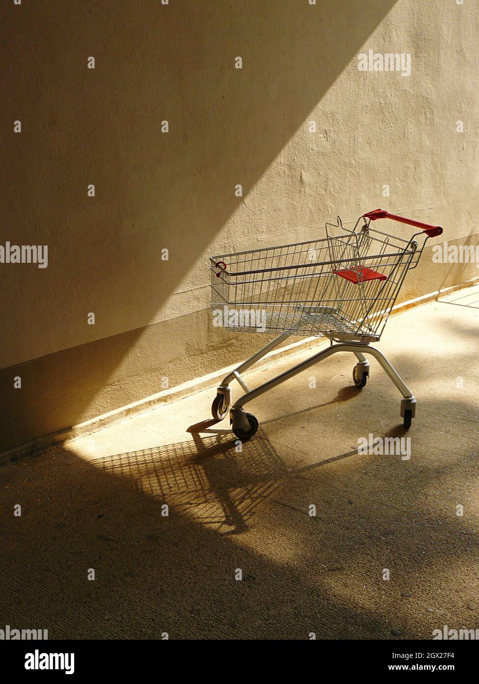 Abandoned Shopping Cart Against Wall Stock Photo Alamy