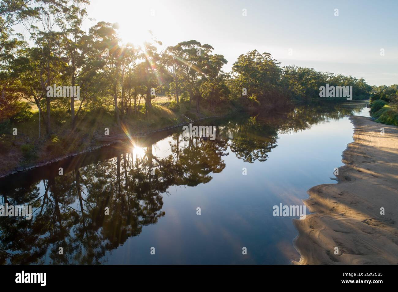 Sunset Over Trees Growing On Snowy River Banks In Orbost, Australia Stock Photo