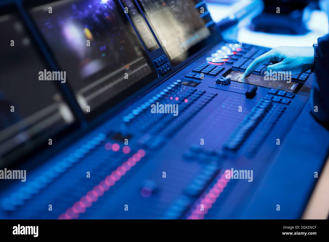 Operator working with stage lighting control panel. Selective focus