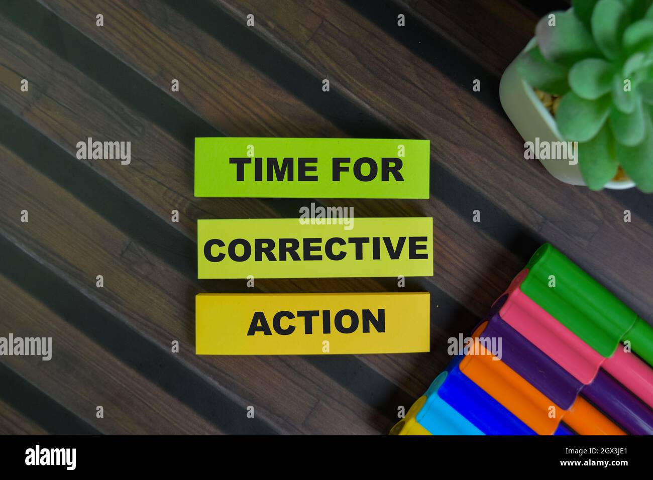 Time For Corrective Action write on sticky notes isolated on Wooden Table. Stock Photo