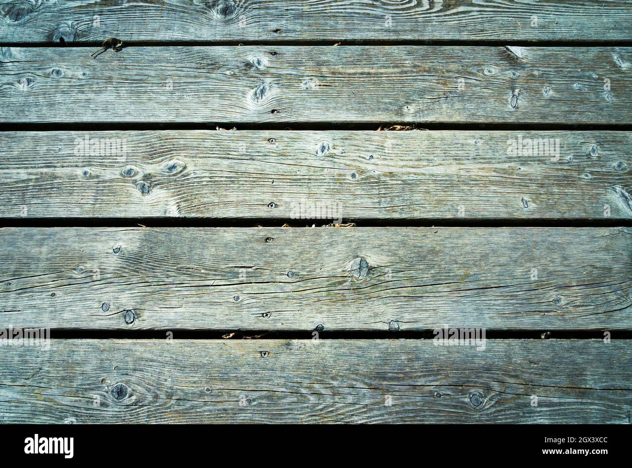 Old wooden planks with bluish tones and lots of texture placed horizontally. Stock Photo