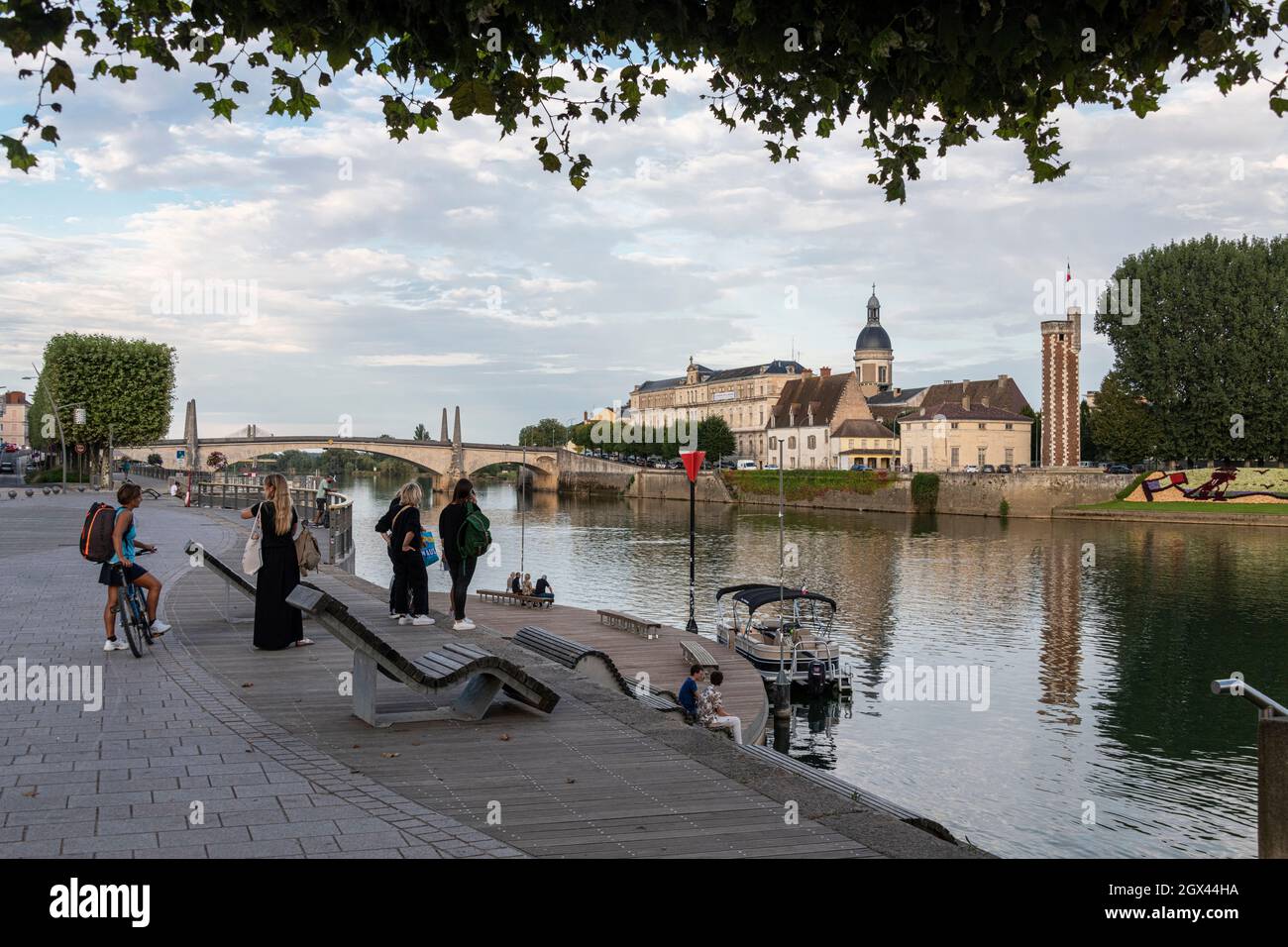 People Talk by the River Saone overlooking the Island of Saint Laurent, Chalon-Sur-Saone, Eastern France. Stock Photo