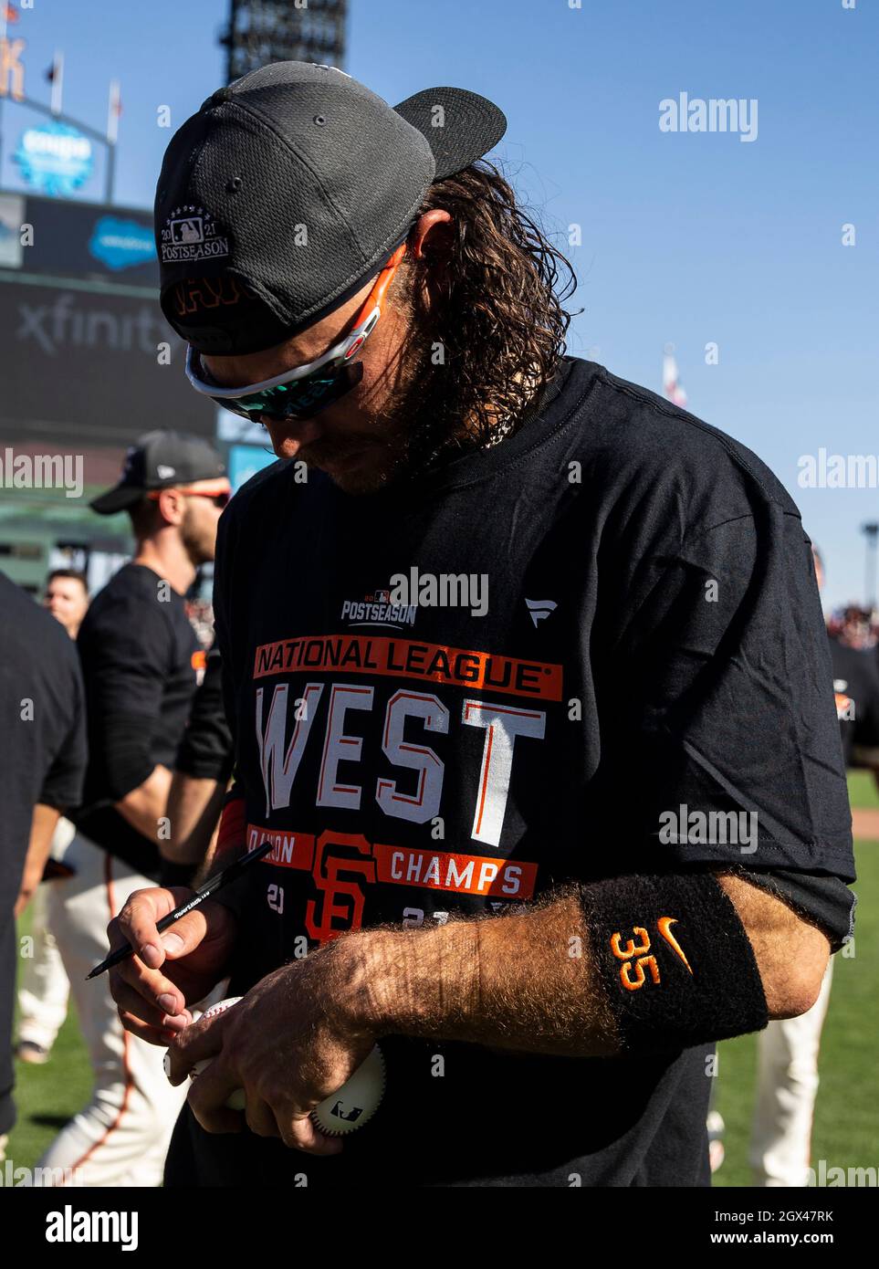 San Francisco, USA. October 03 2021 San Francisco CA, U.S.A. San Francisco  Giants shortstop Brandon Crawford sign baseball during MLB NL west  celebration after the game between the San Diego Padres and