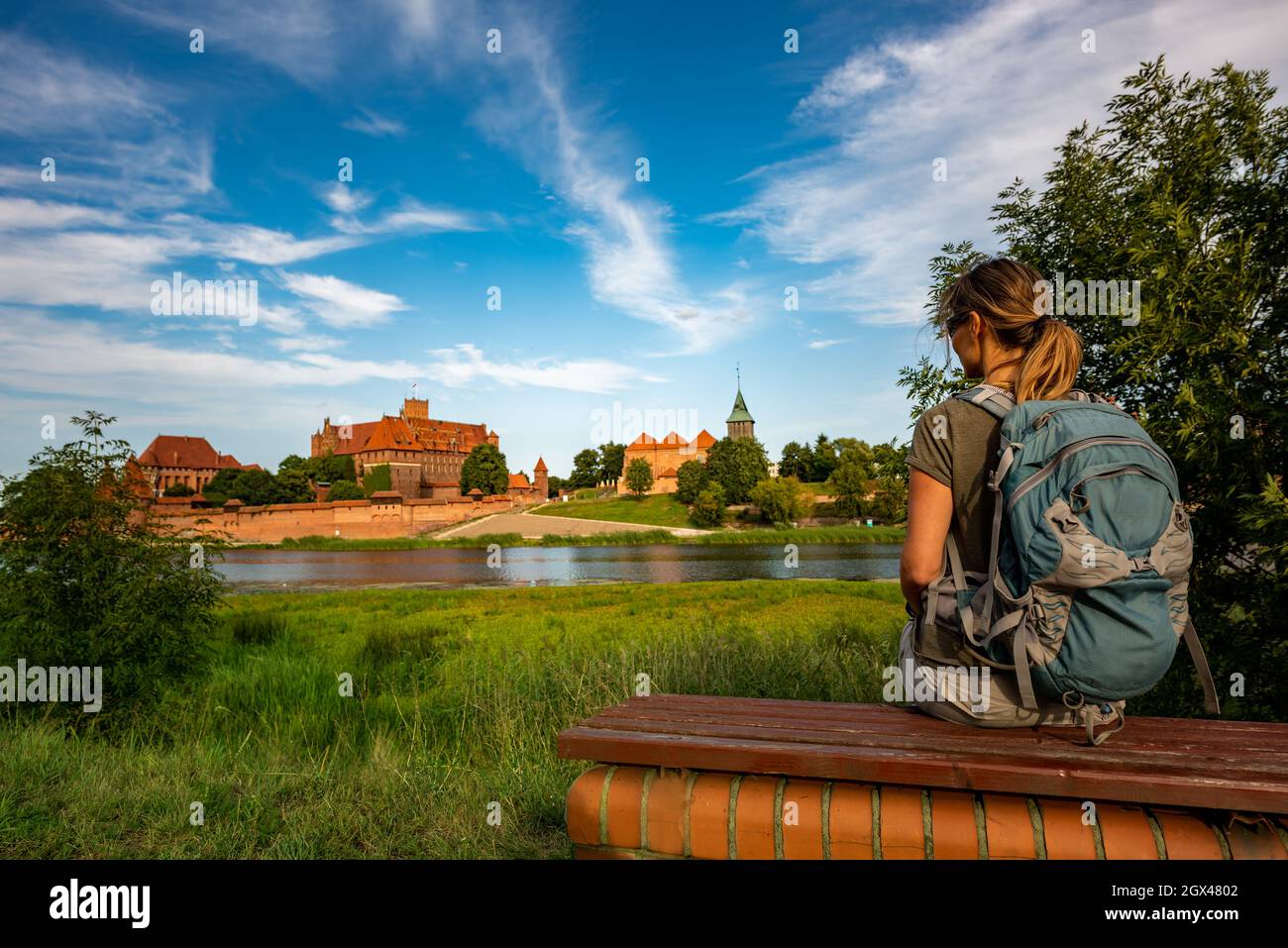 Visiting Poland, tourist enjoys the view of famous unesco site Castle of the Teutonic Order in Malbork Stock Photo