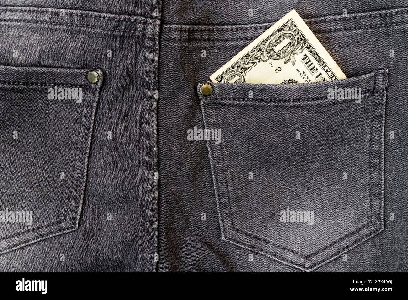 pocket of black jeans. Dollar bills 