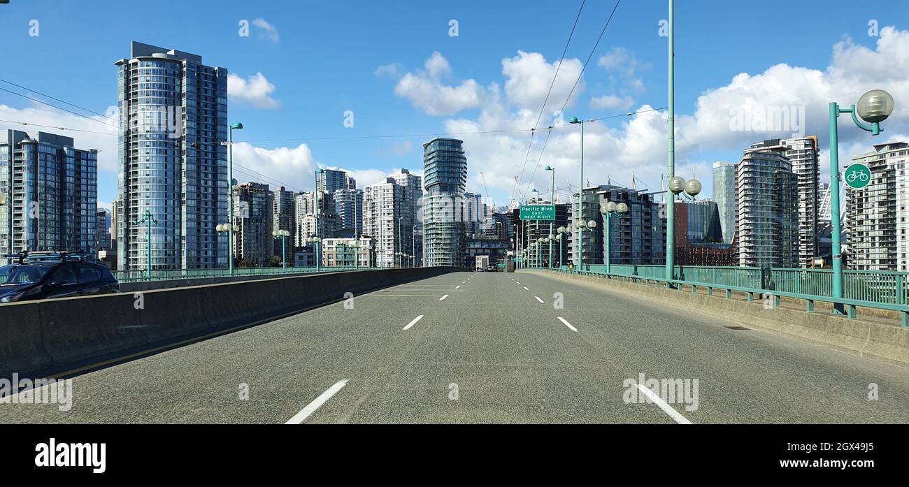 Long highway in a city with skyscrapers Stock Photo - Alamy