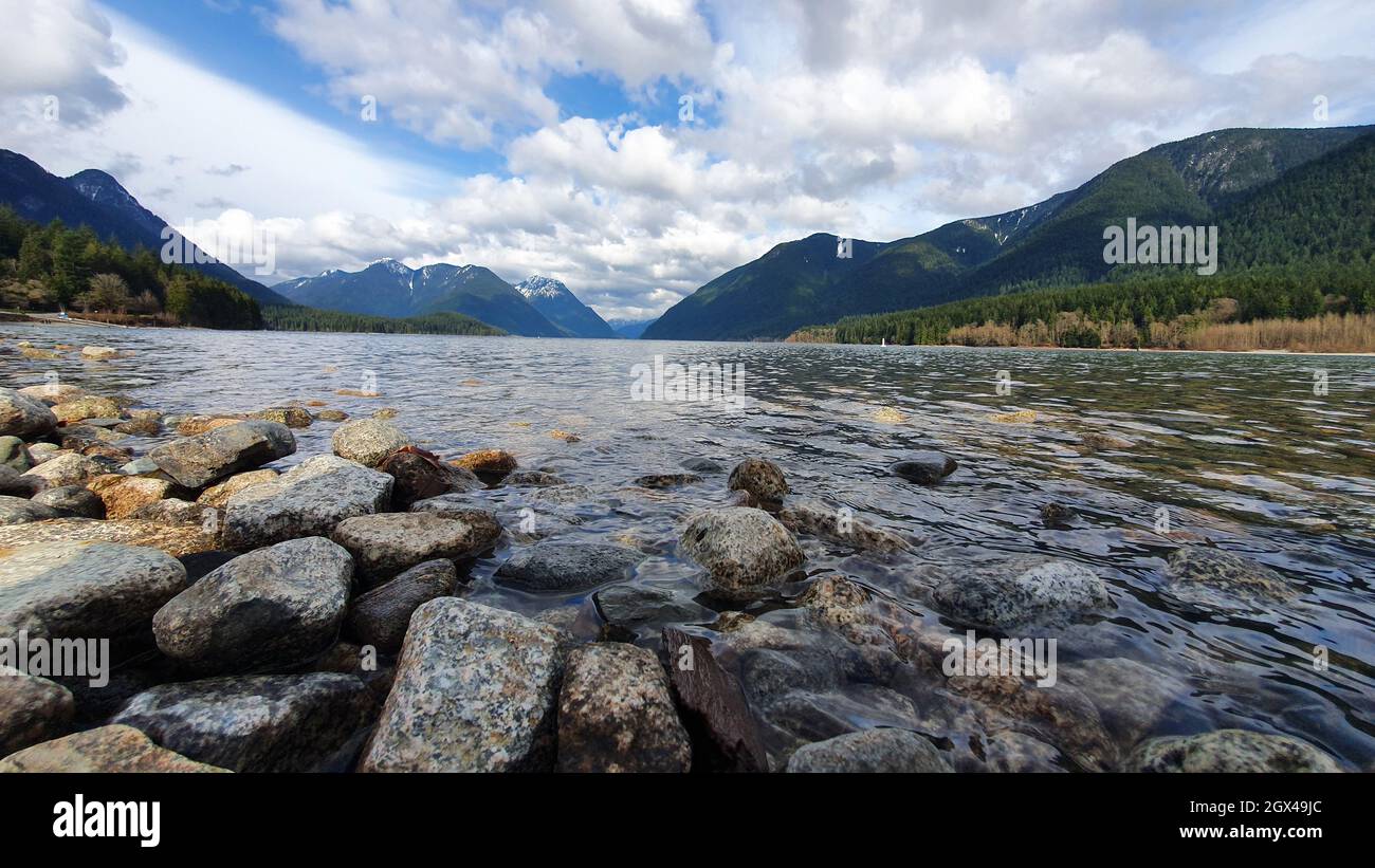 Beautiful view of a river in mountains under the cloudy sky Stock Photo ...